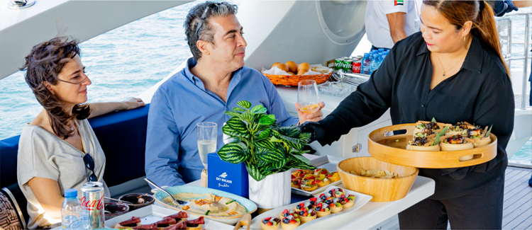Visitors enjoying a dining cruise package on a Dubai yacht